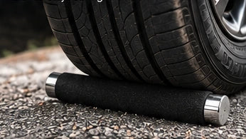 Illustration of a car tire positioned above a metal baton